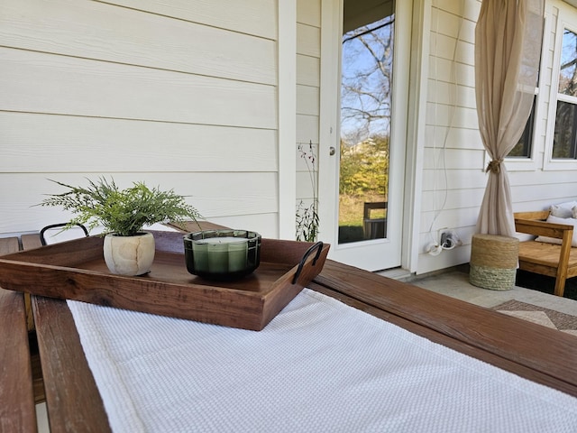 exterior space featuring wooden walls and multiple windows