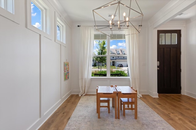 dining space featuring a chandelier and light hardwood / wood-style flooring