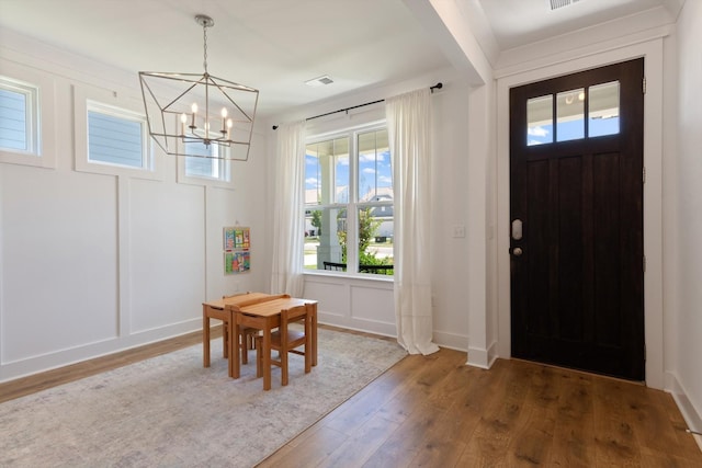 entrance foyer with a chandelier and dark hardwood / wood-style floors