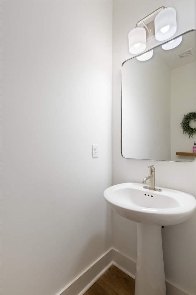 bathroom featuring sink and hardwood / wood-style flooring