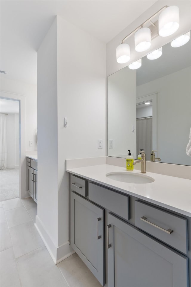 bathroom featuring tile patterned flooring and vanity