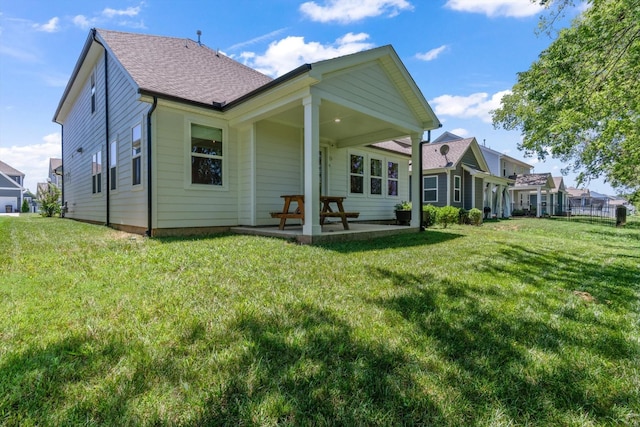 back of house featuring a yard