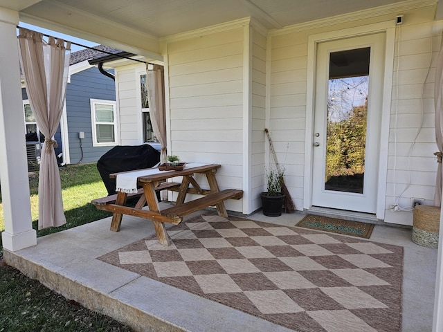 view of patio / terrace with covered porch and a grill