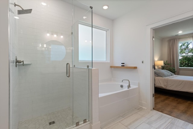 bathroom featuring independent shower and bath and wood-type flooring