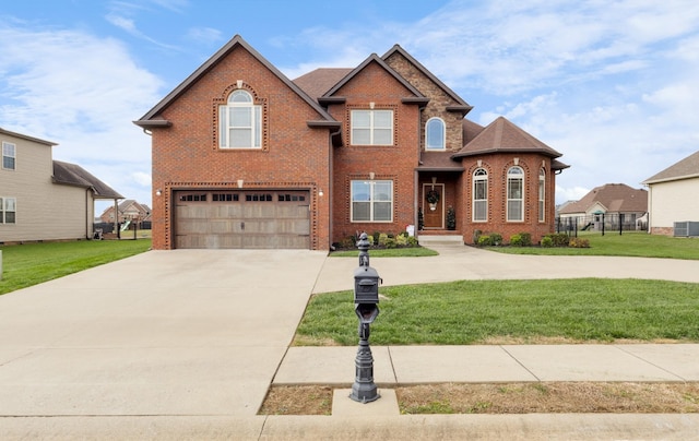 traditional-style home with an attached garage, a front lawn, concrete driveway, and brick siding