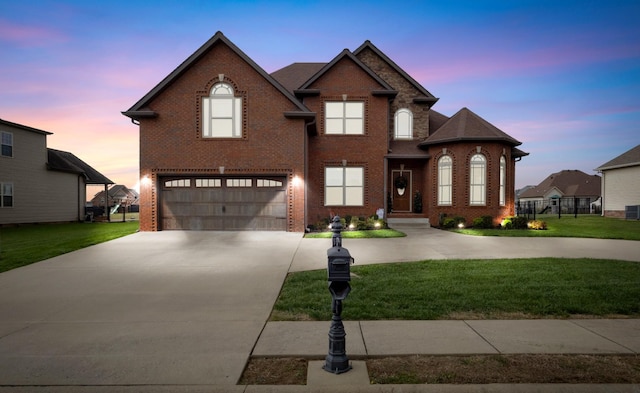 traditional-style home with a front yard, brick siding, driveway, and an attached garage