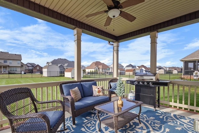 deck with a residential view, a fenced backyard, and a lawn