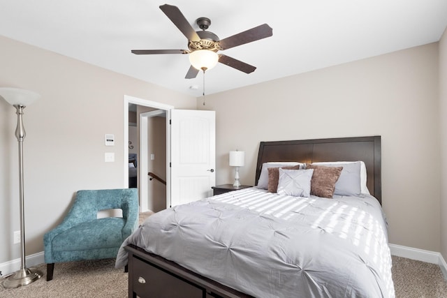 carpeted bedroom with ceiling fan and baseboards