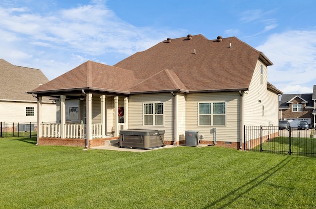 back of house featuring a yard, crawl space, fence, and a hot tub