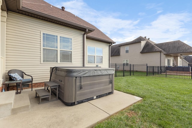 exterior space with a hot tub, a patio, a fenced backyard, roof with shingles, and a yard