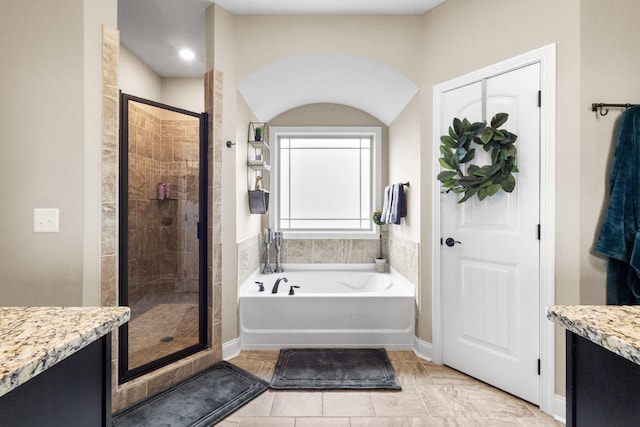 full bath with a stall shower, tile patterned floors, a garden tub, and vanity