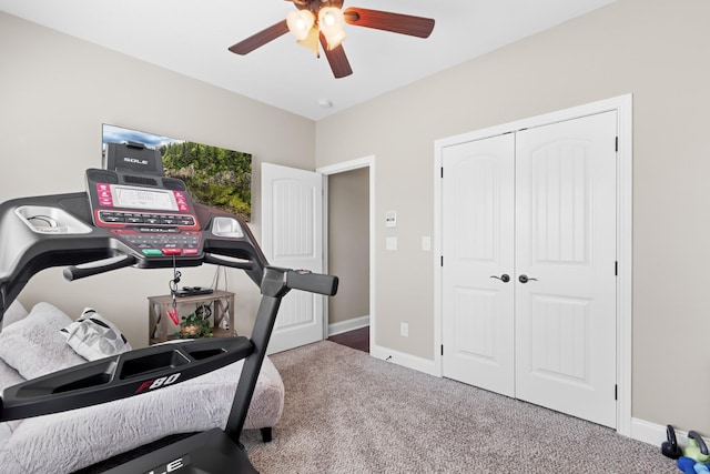 workout area with ceiling fan, carpet, and baseboards