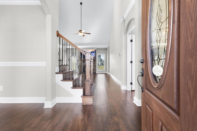 entryway with baseboards, arched walkways, ceiling fan, dark wood-style flooring, and stairs