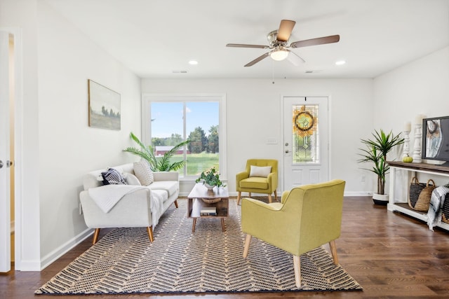 living room with dark hardwood / wood-style floors and ceiling fan