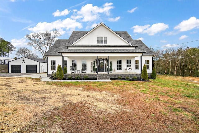 view of front of property with a garage, covered porch, an outdoor structure, and a front yard