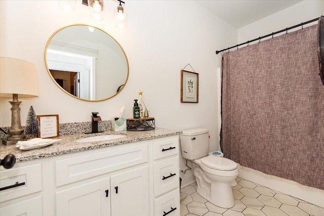 bathroom featuring tile patterned floors, vanity, and toilet