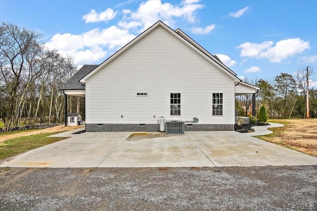 view of side of property featuring cooling unit and a patio area