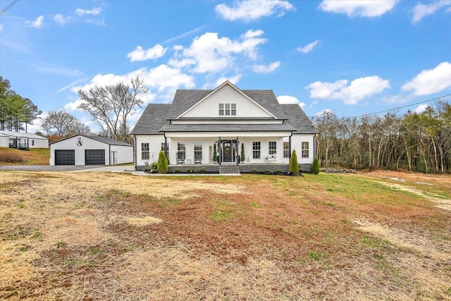 view of front of house with a porch, a garage, a front lawn, and an outdoor structure