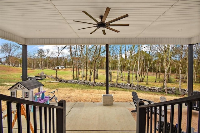 view of patio with ceiling fan and an outdoor structure