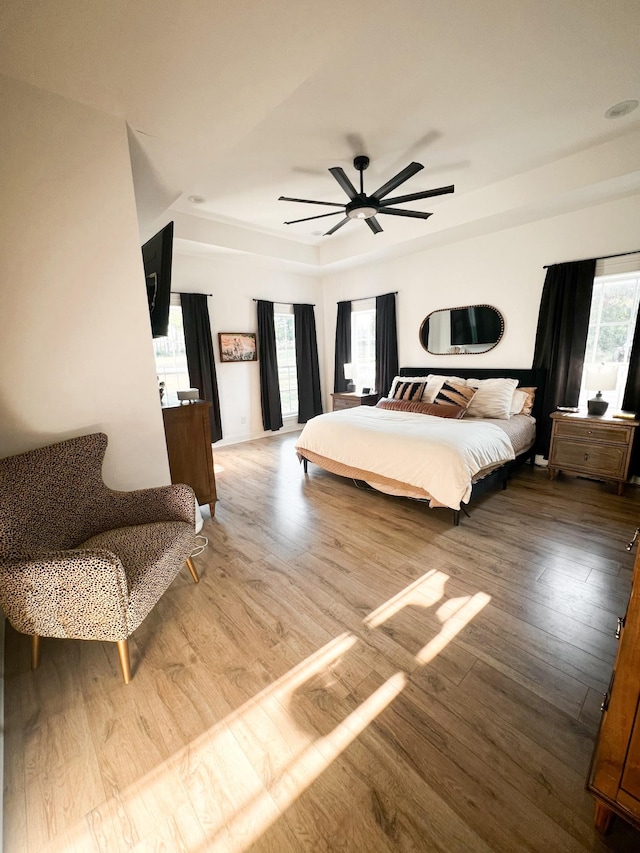 bedroom with hardwood / wood-style floors and ceiling fan