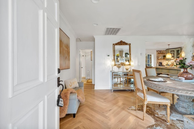 dining room with light parquet floors and ornamental molding