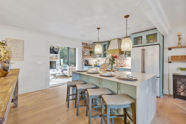 kitchen with a center island, hanging light fixtures, and crown molding