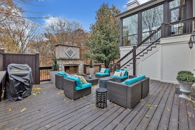 wooden terrace featuring an outdoor living space with a fireplace