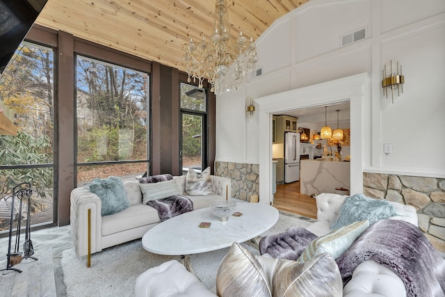 living room featuring a chandelier, hardwood / wood-style floors, high vaulted ceiling, and wood ceiling