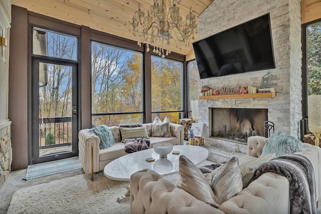 living room with a fireplace, high vaulted ceiling, and a chandelier