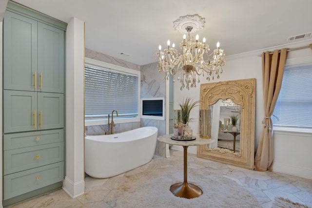 bathroom with a washtub and an inviting chandelier