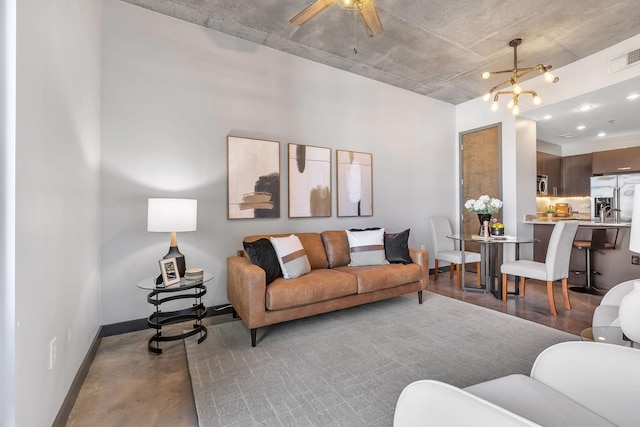 living room featuring ceiling fan with notable chandelier