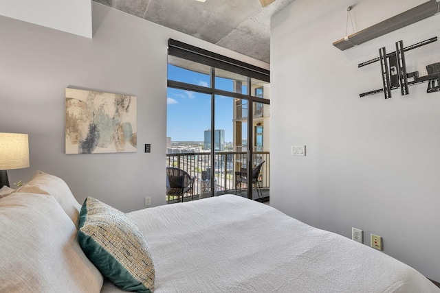 bedroom featuring access to exterior and floor to ceiling windows