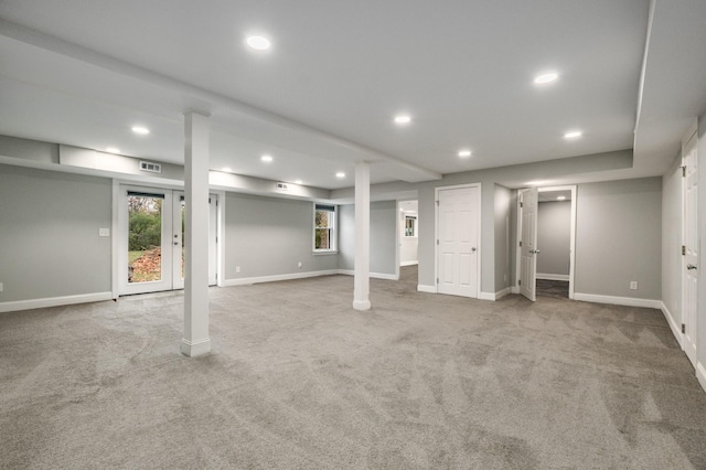 basement featuring light colored carpet