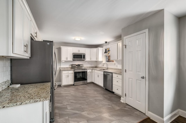 kitchen with white cabinets, pendant lighting, and appliances with stainless steel finishes