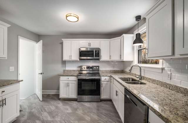 kitchen featuring hanging light fixtures, white cabinetry, sink, and appliances with stainless steel finishes