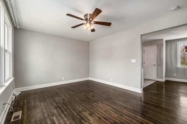 spare room featuring ceiling fan and dark hardwood / wood-style flooring