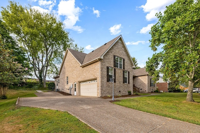 view of side of property with a yard and a garage