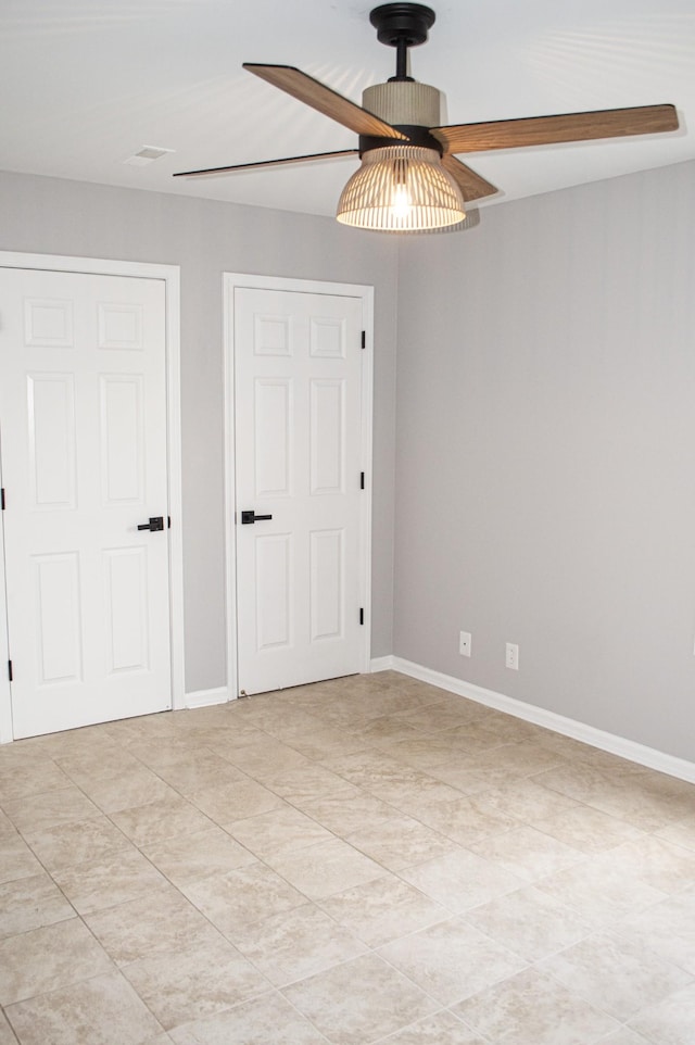 unfurnished bedroom featuring ceiling fan and light tile patterned floors