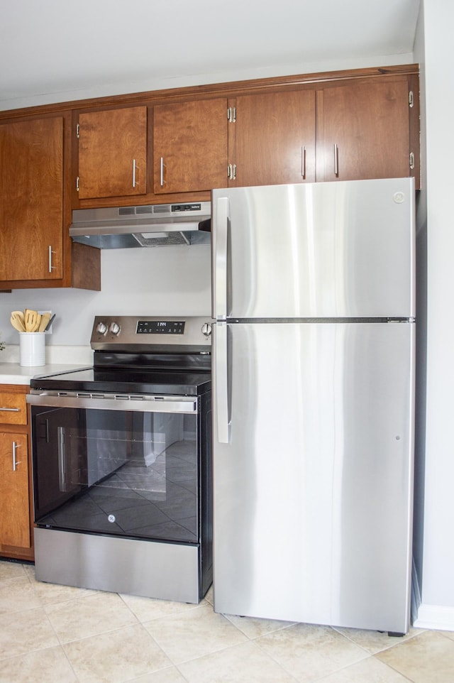 kitchen with light tile patterned flooring and stainless steel appliances