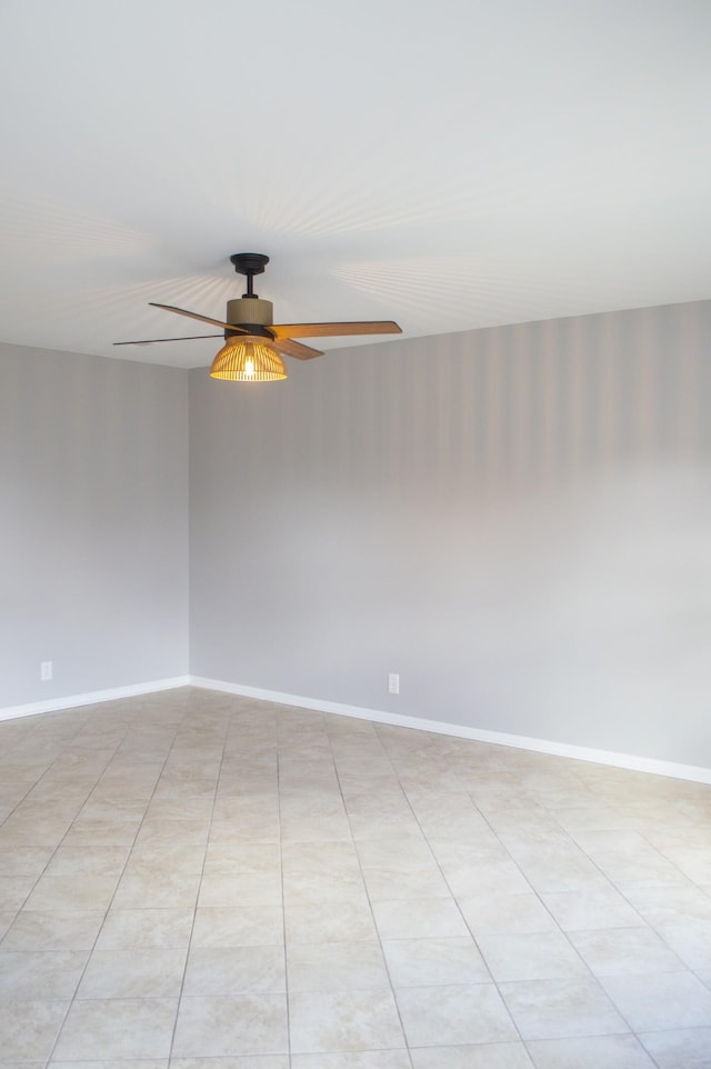 empty room featuring ceiling fan and light tile patterned floors