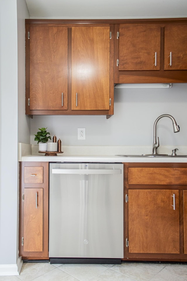 kitchen featuring dishwasher, light tile patterned floors, and sink