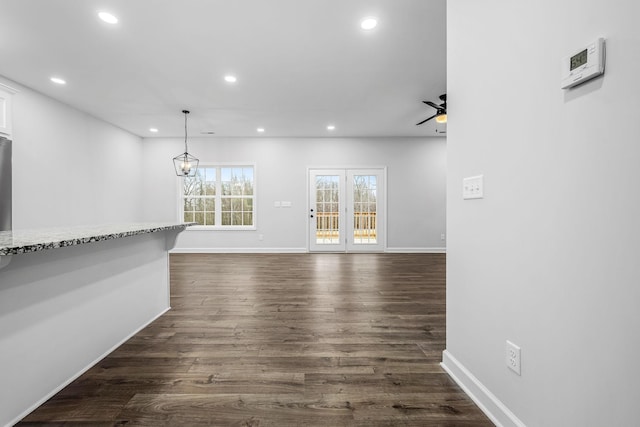 unfurnished dining area featuring recessed lighting, baseboards, dark wood-type flooring, and a ceiling fan