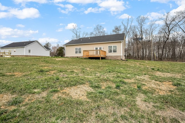 rear view of house with a yard and a deck