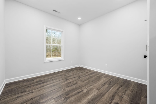 spare room featuring recessed lighting, visible vents, baseboards, and dark wood-style flooring