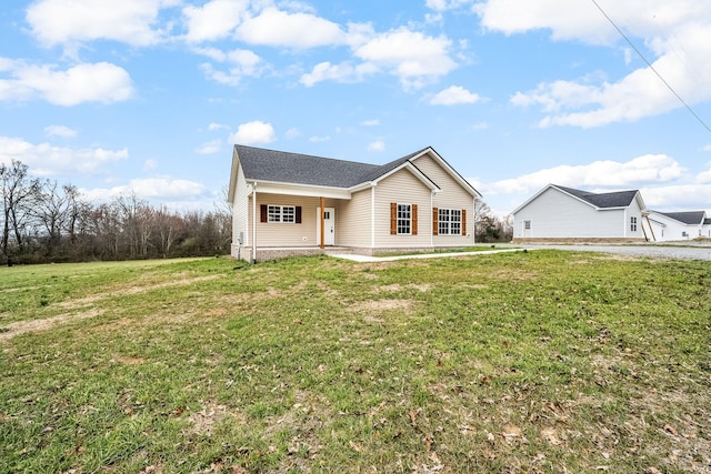 ranch-style house with a front yard and covered porch