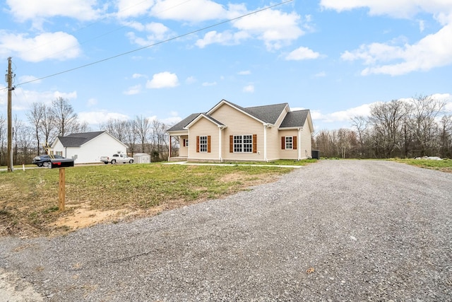 view of front of property with a front lawn, central air condition unit, and driveway