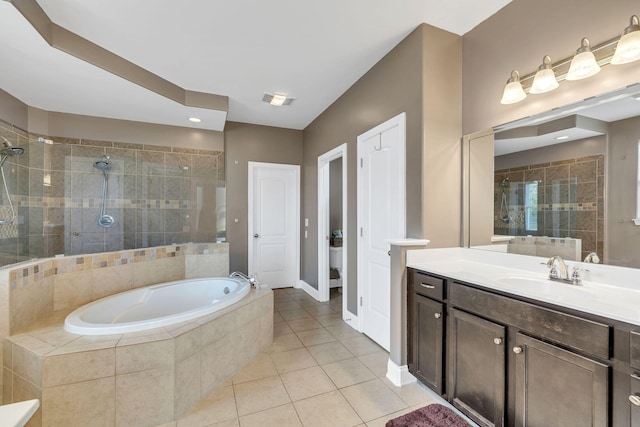 bathroom with vanity, tile patterned flooring, and plus walk in shower