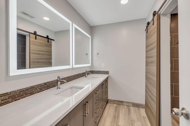 bathroom with decorative backsplash and vanity