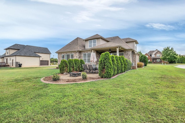 back of house with a patio area, a yard, and a fire pit