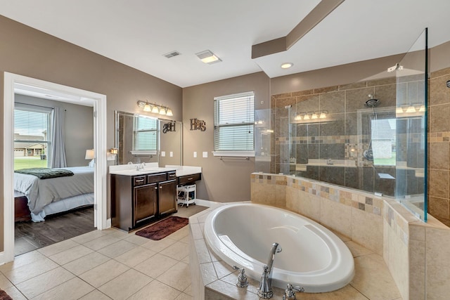 bathroom with vanity, tile patterned floors, and plus walk in shower